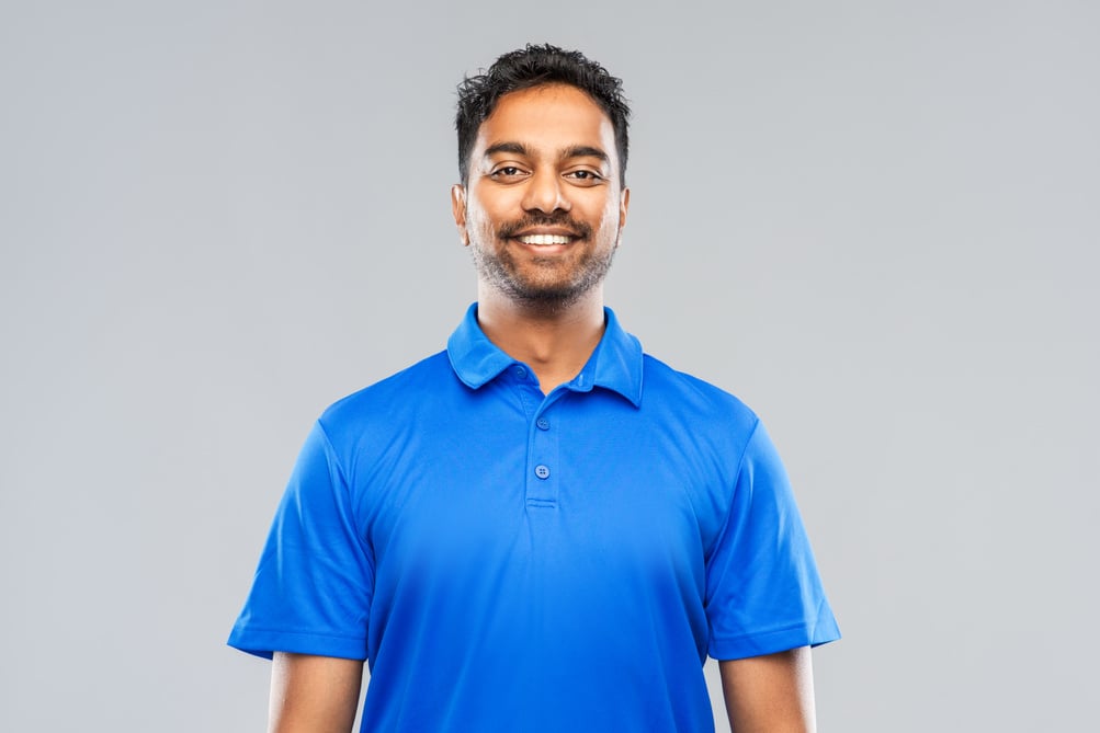 Man in Blue Polo Shirt on Gray Background